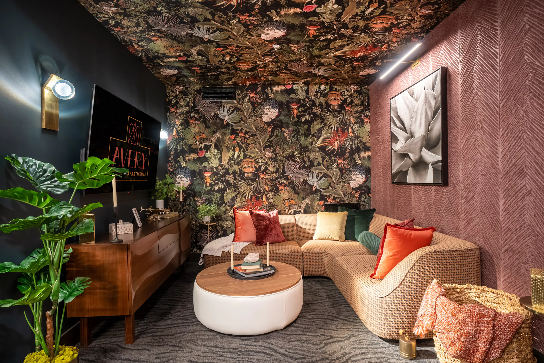 Lounge seating with patterned walls and a television.