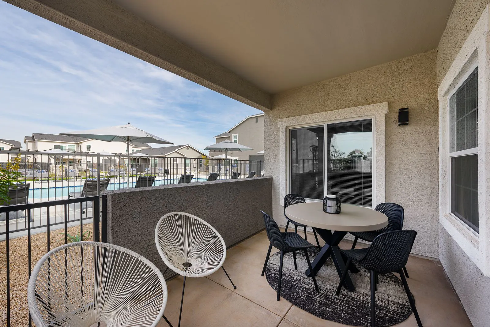 Covered patio seating overlooking the pool.