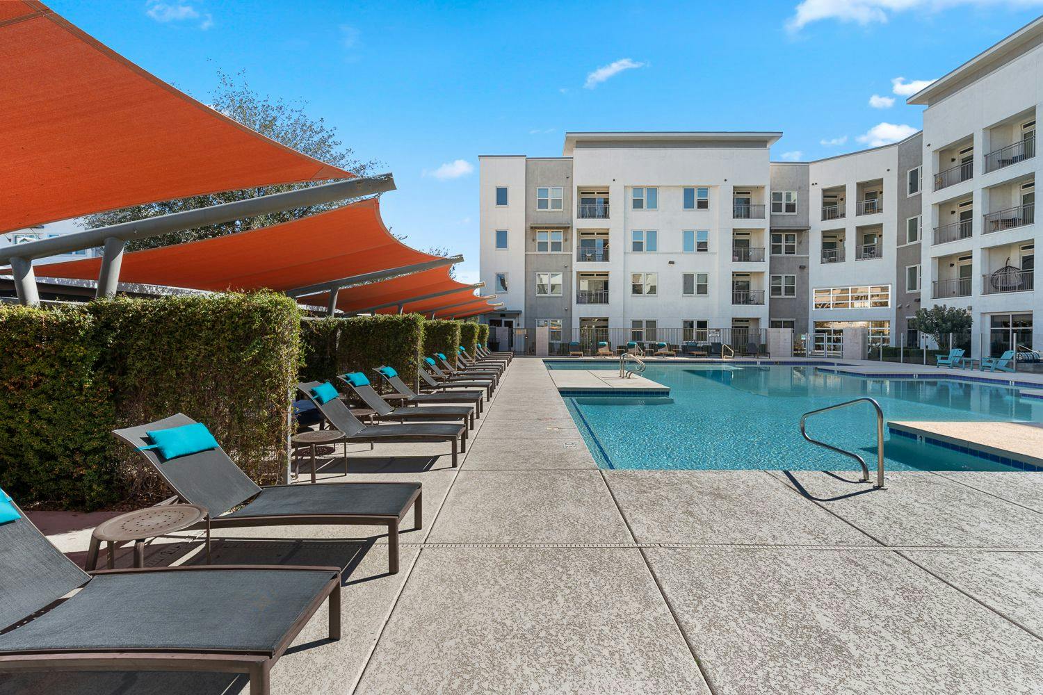 Expansive Resort-Style Pool with Pool Deck and Lounge Chairs